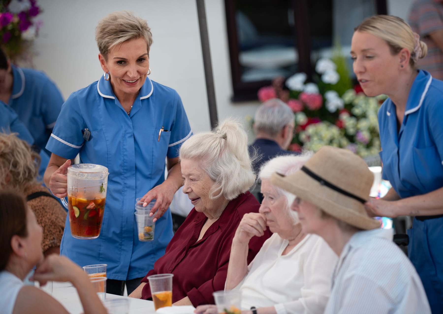 Residents and guests enjoying the summer BBQ at Hollymead House